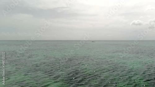 Flying over fisherman's boat next to Bantayan island, Cebu, Philippines. turquoise tropical lagoon photo