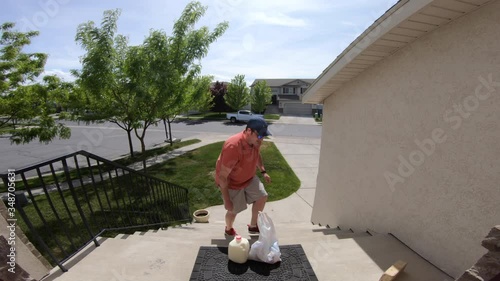 Man Delivering Groceries to House Front Door