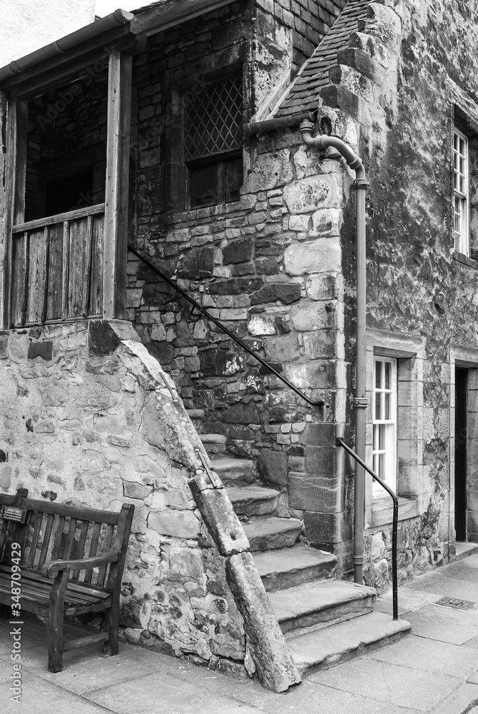 Old house entrance with stairs and corridor. Black and white. 