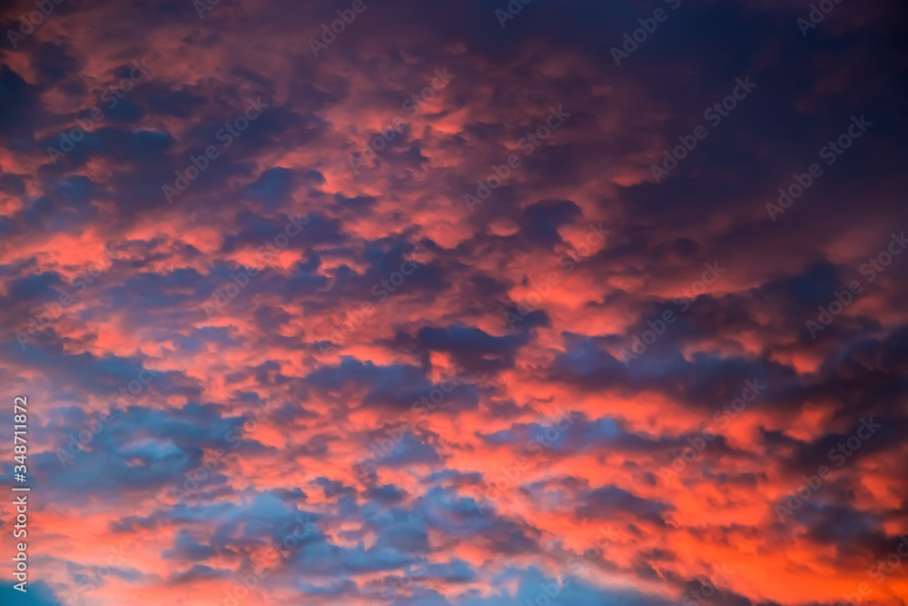 Beautiful sky at sunset. Purple and pink unusual clouds. Blurred background for design.