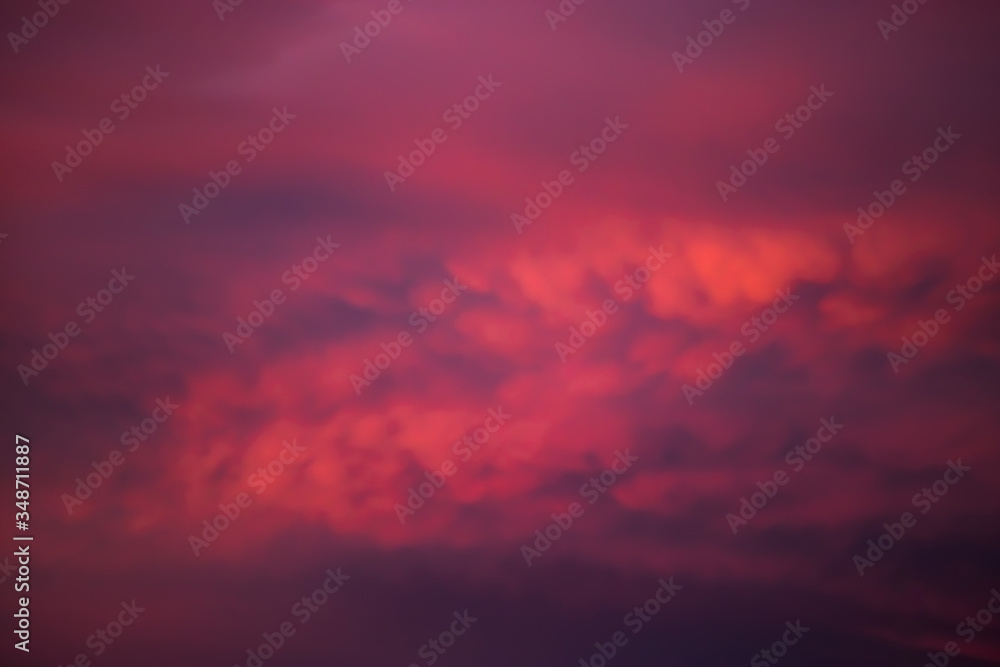Beautiful sunset on the sky. Purple clouds in the sun. Blurred background for design. Selective focus. Beautiful sunset on the sky. Purple clouds in the sun. Blurred background for design. Selective focus.