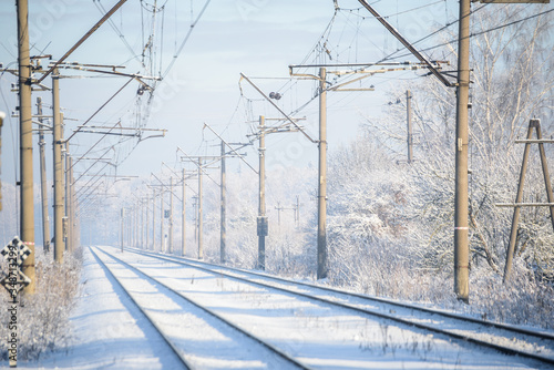 Train tracks in winter with frost covering around