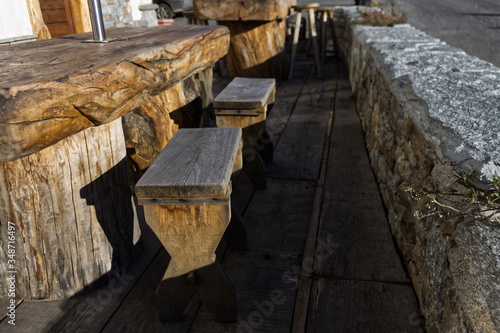 benches and tables made from a single wooden trunk in a cottage