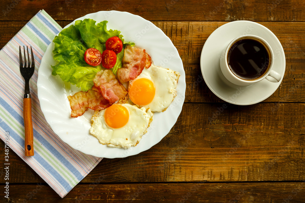 Breakfast on a wooden table. Coffee fried egg with bacon. Breakfast on a wooden table. Coffee fried egg with bacon.