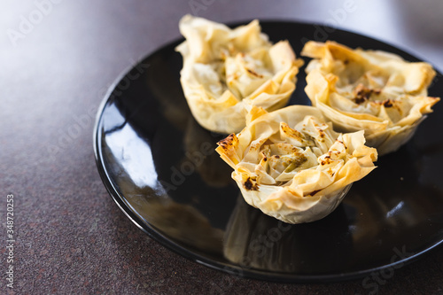 Obraz na plátně plant-based food, filo pastry cups with vegan filling just out of the oven
