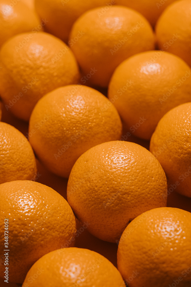 close up row of fresh oranges. angled top view