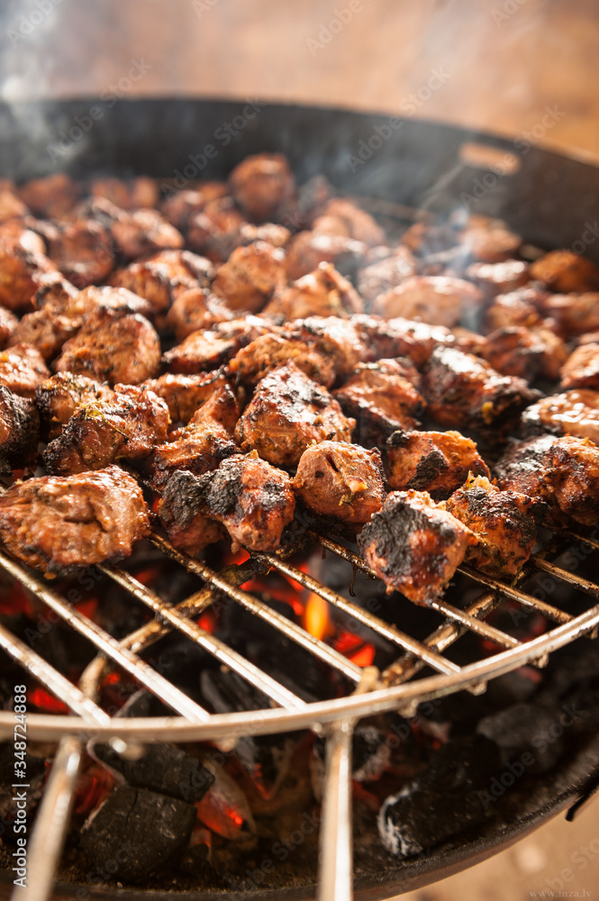 Shashlik grilling on grill with live flame Shashlik grilling on grill with live flame