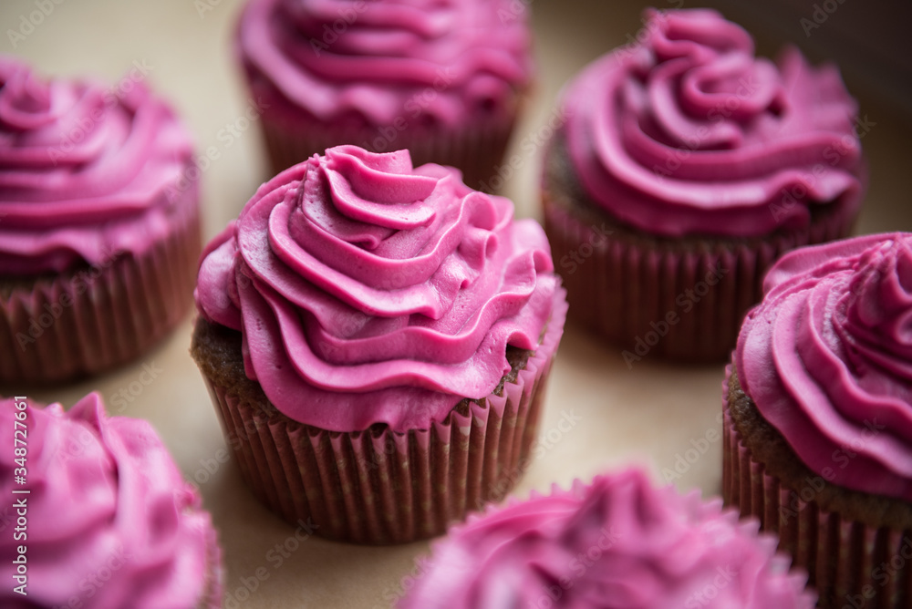 Chocolate cupcakes with raspberry cream on top Chocolate cupcakes with raspberry cream on top