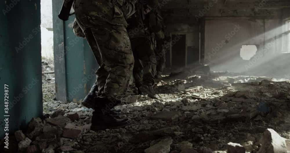 Group of soldiers walking together with equipment on a battlefield Group of soldiers walking together with equipment on a battlefield