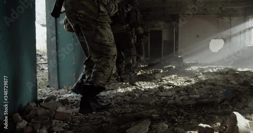 Group of soldiers walking together with equipment on a battlefield