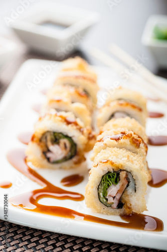 Hot sushi amay maki with sauce on a dish