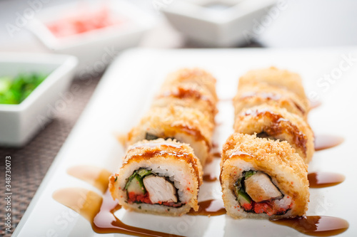 Hot sushi amay maki with sauce on a dish photo