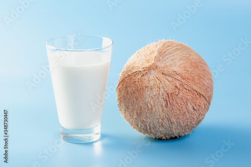 Coconut  with coconut milk  on blue ground