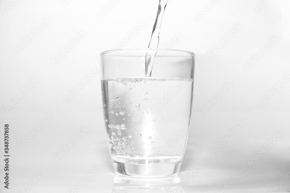 bright water dripping into the glass with many bubble in water bright blue background . healthcare drinking advertising concept bright water dripping into the glass with many bubble in water bright blue background . healthcare drinking advertising concept