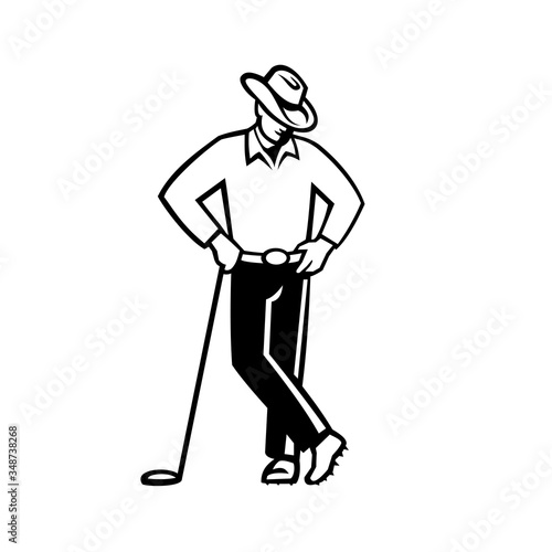 Illustration of a cowboy golfer wearing a hat leaning on golf club viewed from front on isolated background done in black and white in retro style.