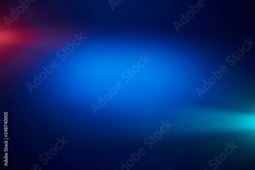 Light blue and light red rays of light around a blue volumetric glow