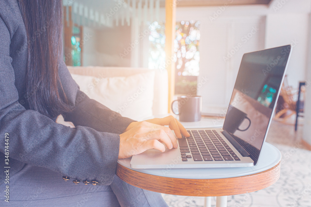Business women hand use laptop computer.