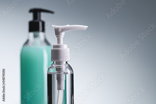 Hand sanitizers, protection against viruses and bacteria. Two bottles of spray, gel and alcohol antiseptic. Close-up, copy space.