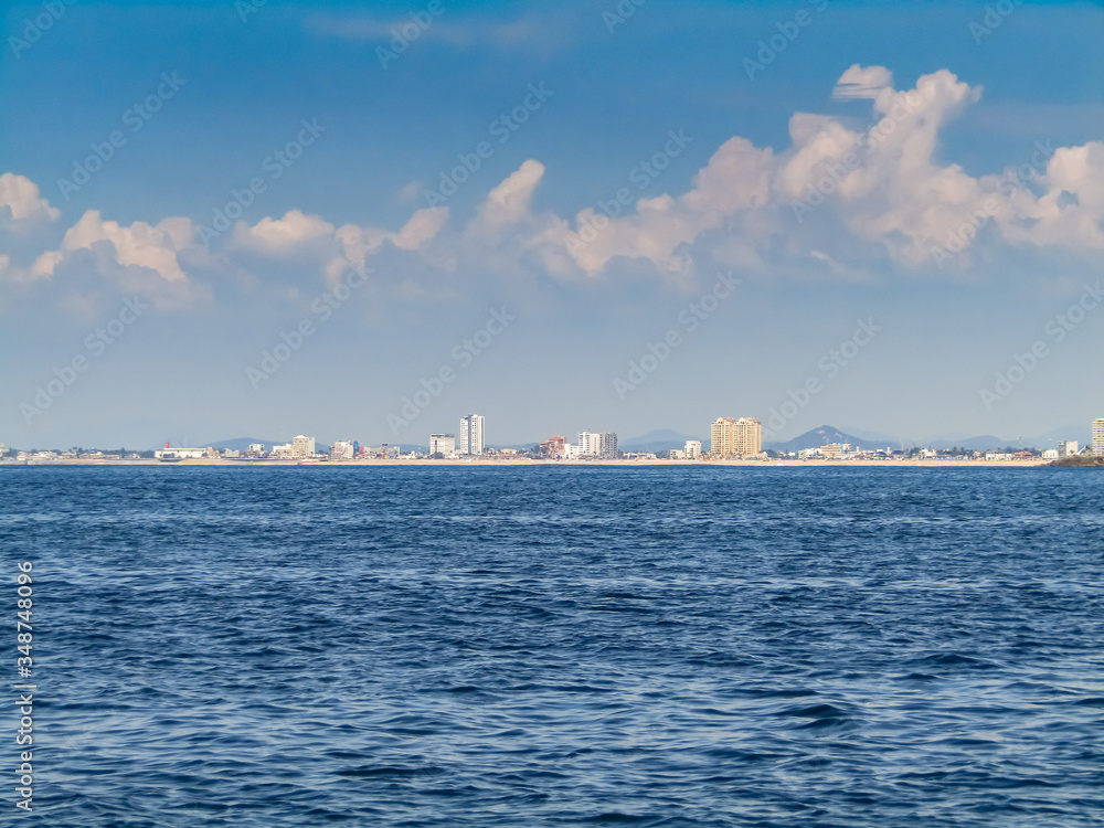 Panoramic view of the coast since the sea. Mazatlan port, Sinaloa, Mexico. Blue sky.