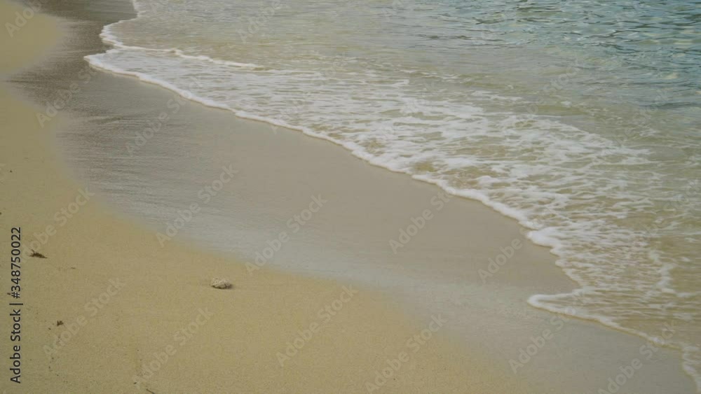 Close up of waves moving onto shore, sandy beach, static tropical nature shot Close up of waves moving onto shore, sandy beach, static tropical nature shot