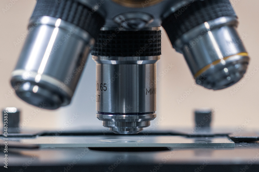 Close up of examining of test sample under the microscope in laboratory. Close up of examining of test sample under the microscope in laboratory.