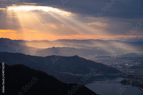 Beautiful sunrise and light beam over kawaguchiko lake and Kawaguchiko town in Japan