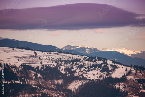 mountains with pine forests at the end of winter