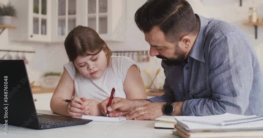 Daughter studying at home with his father Daughter studying at home with his father