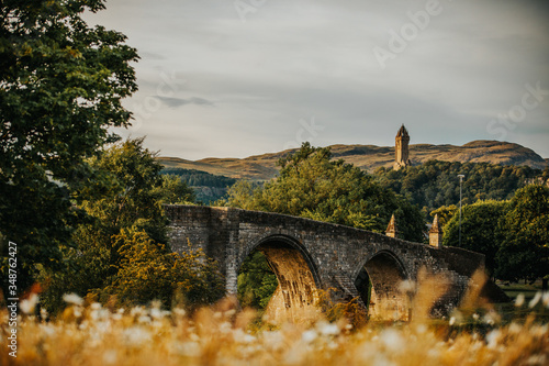 Фотография William Wallace Monument with old stone bridge over the river Stirling Scotland