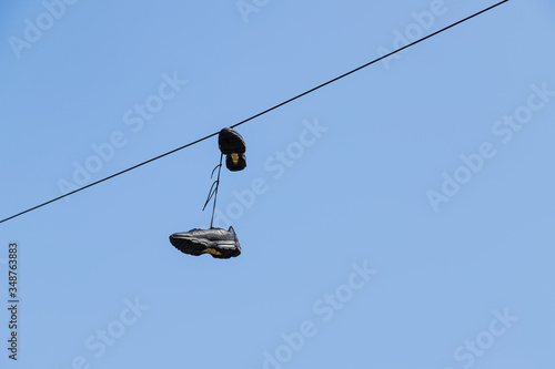 Shoes hanging from a telephone wire