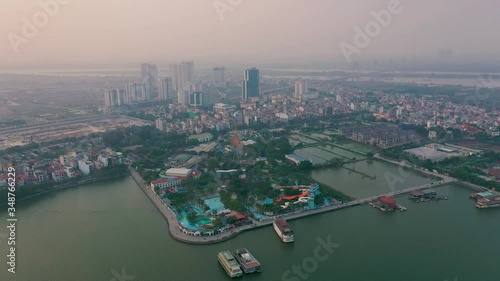 HANOI, VIETNAM - APRIL, 2020: Aerial panorama view of the amusement park near west lake and cityscape of Hanoi. photo