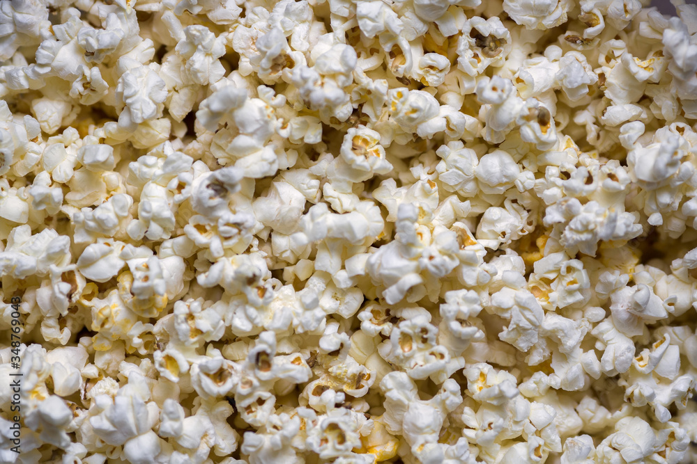 A scattering of cooked popcorn. View from the top. Background. A scattering of cooked popcorn. View from the top. Background.