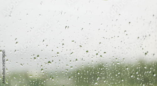 Rainwater splashing makes the window glass wet.