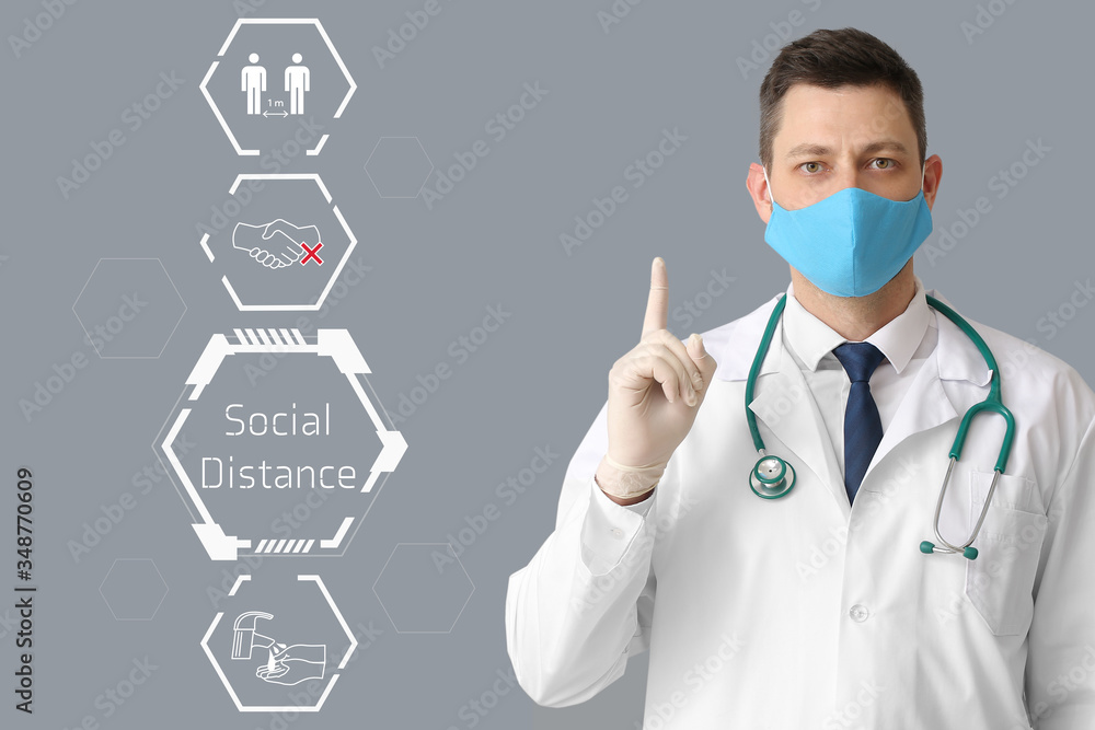 Doctor in protective medical mask on grey background. Concept of epidemic Doctor in protective medical mask on grey background. Concept of epidemic