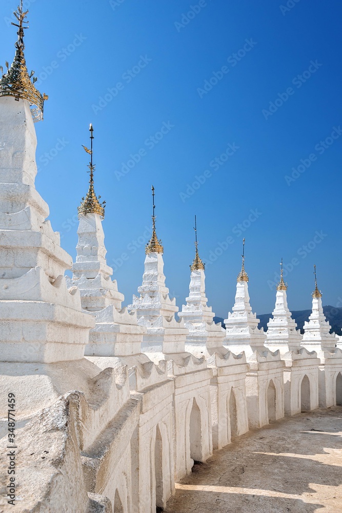 Amazing parts of White Hsinbyume Pagoda (Mya Thein Dan pagoda) in Mingun near Mandalay, Myanmar (Burma) on Western bank of Irrawaddy river on the background of blue sky