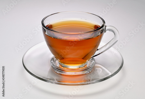 Tea in transparent glass cup on white background