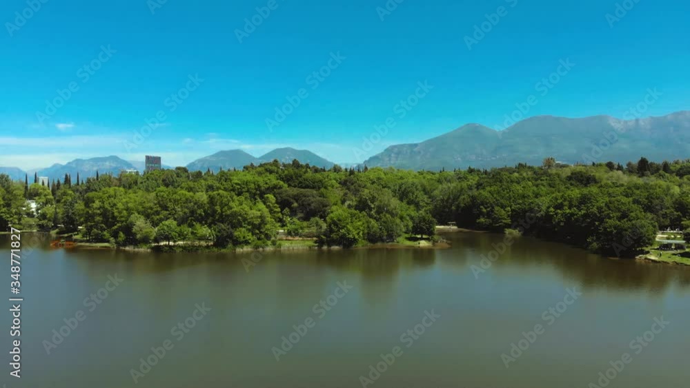 Lake with calm water reflecting trees of city park on a spring shiny day with bright blue sky in Tirana Lake with calm water reflecting trees of city park on a spring shiny day with bright blue sky in Tirana
