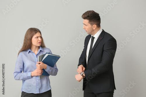 Angry boss scolding his sec...