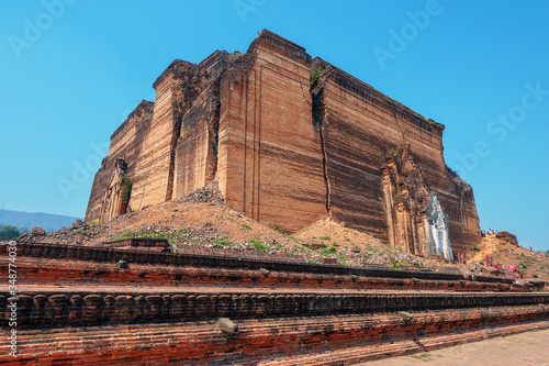monumental uncompleted stupa Pahtodawgyi Paya destroyed by earthquake in Mingun Mandalay, Myanmar (Burma) on Western bank of Irrawaddy river on the background of blue sky