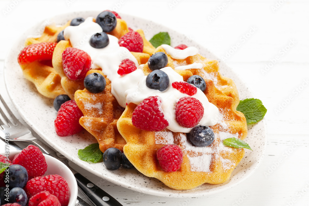 Delicious belgian waffles with summer berries Delicious belgian waffles with summer berries