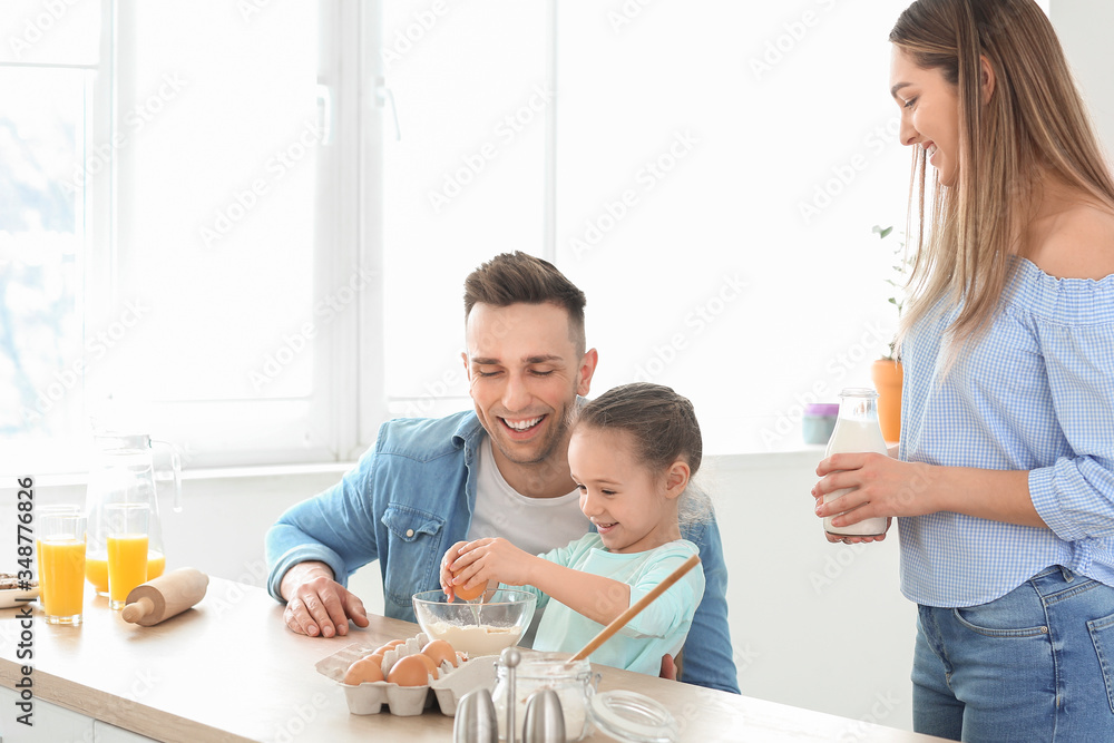 Happy family making dough together in kitchen