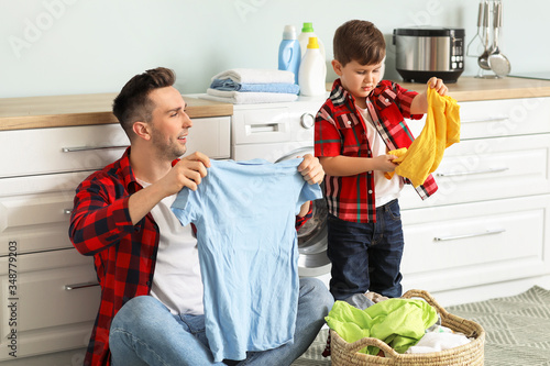 Man and his little son doin...