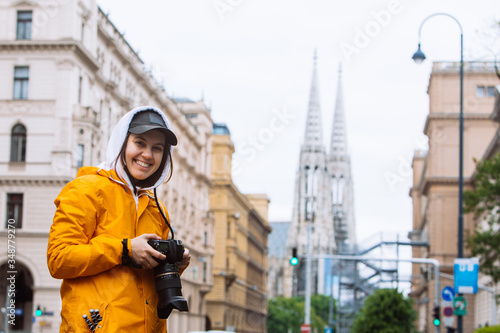 Photography photographer tourist taking picture of city street with votive church on backgro