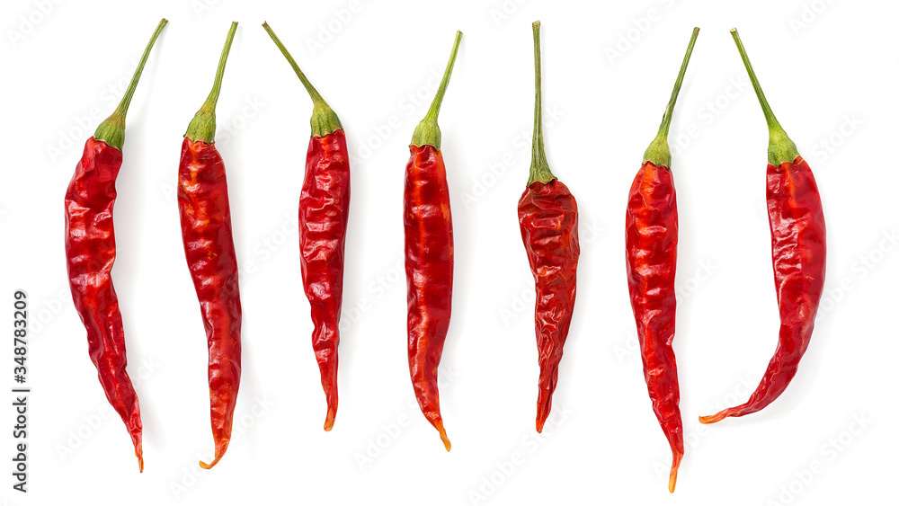 Hot red dry chili peppers isolated on white background, banner. Top view, flat lay. Hot red dry chili peppers isolated on white background, banner. Top view, flat lay.