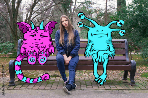 A girl with long hair is sitting and sad on a Park bench with her imaginary monster friends. Drawing on top of the photo