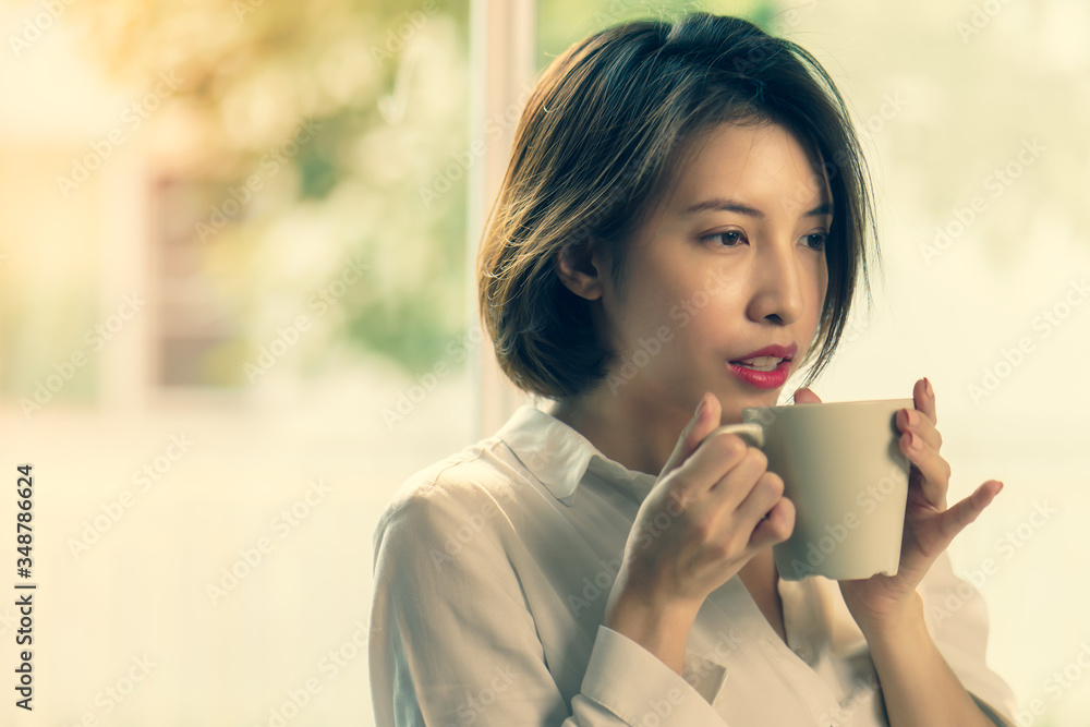 Woman hands holding hot cup of coffee or tea in morning sunlight. Woman hands holding hot cup of coffee or tea in morning sunlight.