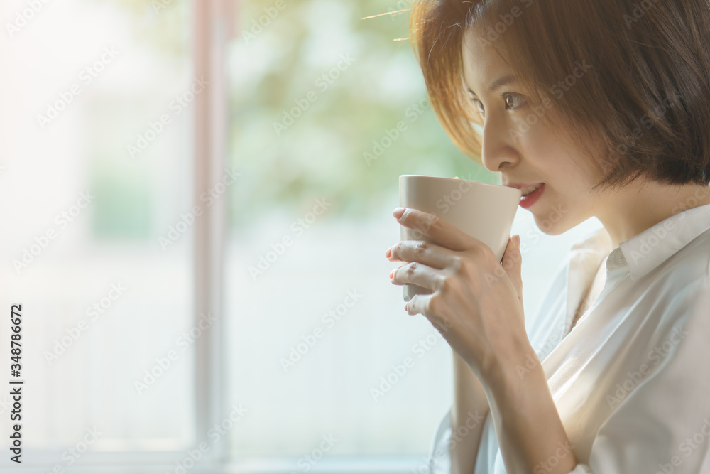 Woman hands holding hot cup of coffee or tea in morning sunlight. Woman hands holding hot cup of coffee or tea in morning sunlight.
