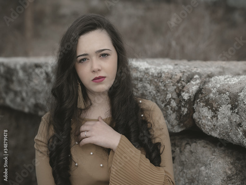 Portrait of young woman next to a wall. photo