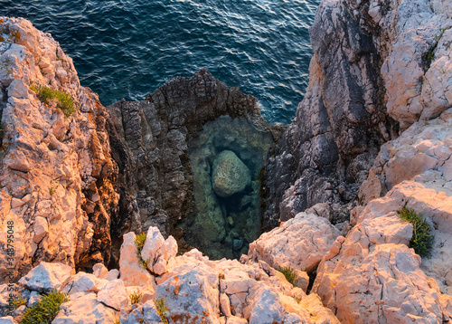 Fototapeta Naklejka Na Ścianę i Meble -  A big rock under kamenjak deep blue sea, Premantura, Croatia