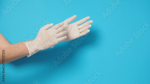 Two hand wearing white gloves and right hand is pulling.Put on blue background.